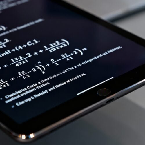 An image of a smartphone displaying complex mathematical equations, representing online tools and resources available for website development and analysis.